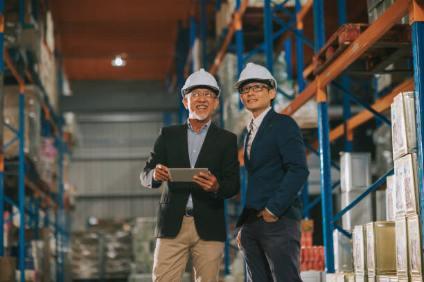 istock asian chinese management having discussion at warehouse with white hardhat using digital tablet 1318322447
