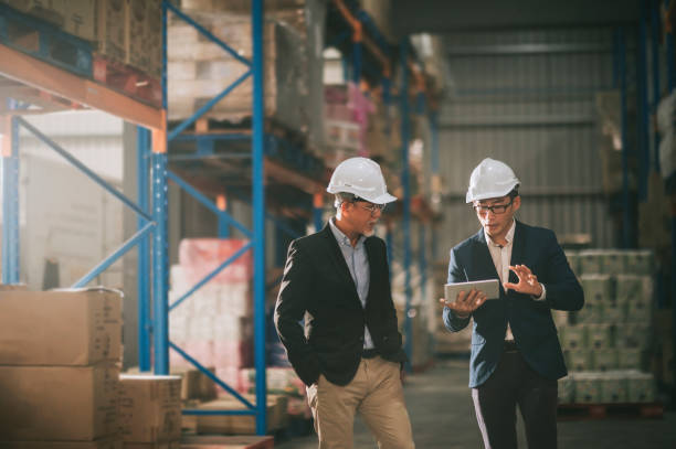 istock asian chinese management having discussion at warehouse with white hardhat using digital tablet 1318322449