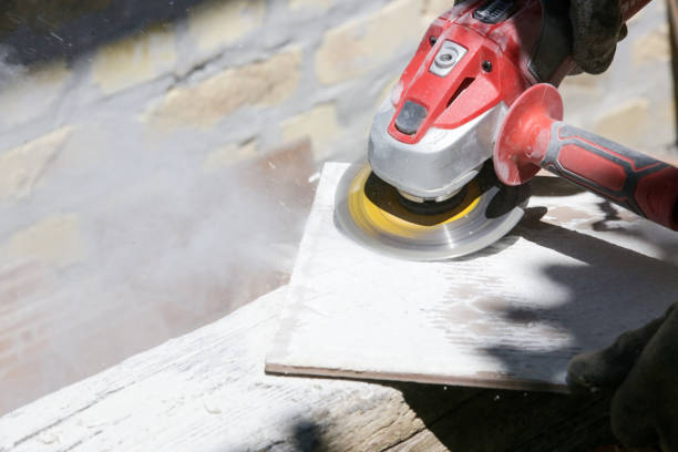 istock Removing mortar and glue from old tiles for reuse. 1318322457