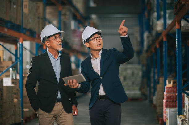 istock asian chinese management having discussion at warehouse with white hardhat using digital tablet 1318322462