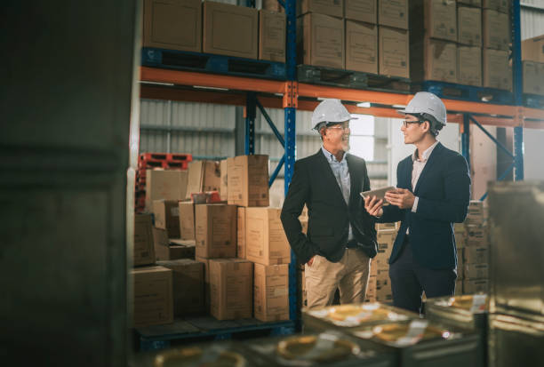 istock asian chinese management having discussion at warehouse with white hardhat using digital tablet 1318322467