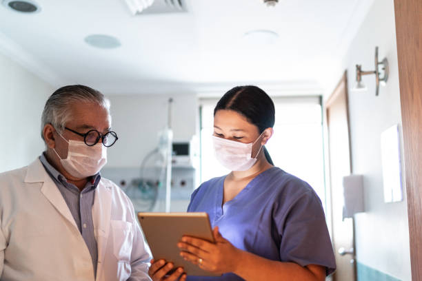 istock Nurse talking to doctor and using digital tablet at the hospital 1318322762