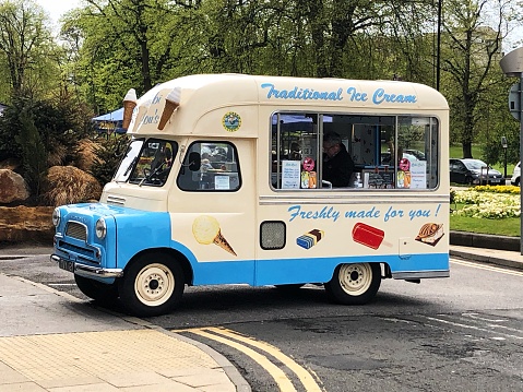 Harrogate, UK - May 9, 2021.  A traditional and old fashioned ice cream van selling 99s and choc ices to the public in the UK.