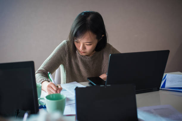 istock Young Asian Chinese woman working with laptop in office 1318324949