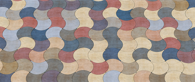 Artificial textured cobblestone surface with multi-colored neat jigsaw tile pieces - horizontal close-up composition