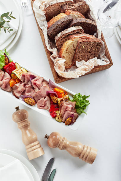 Sliced Beef or Pork with Marinated Vegetables and Sauce. Beautifully decorated catering banquet menu. Food snacks and appetizers for buffet on white background