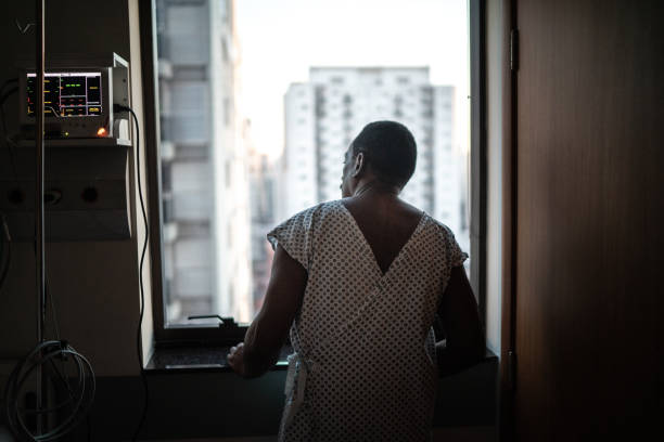 vista trasera de un paciente en el hospital mirando a través de la ventana - patience fotografías e imágenes de stock