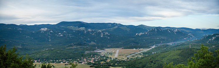 Panoramic view of Grobnik amateur runway and circuit with mountains in a background. Picture taken from Grobnik Castle. Next to runway is Podhum village.