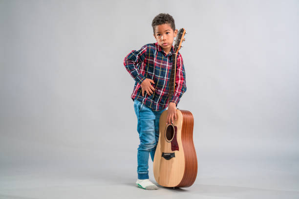 istock Mixed Race Child Holding a Guitar 1318330977