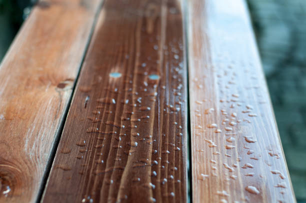 water drops on the lacquered planks of a garden bench after rain