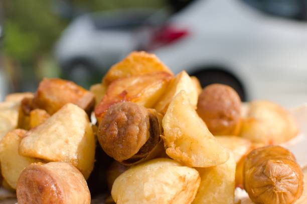 istock appetizing fried potatoes and sausages on table 1318333559