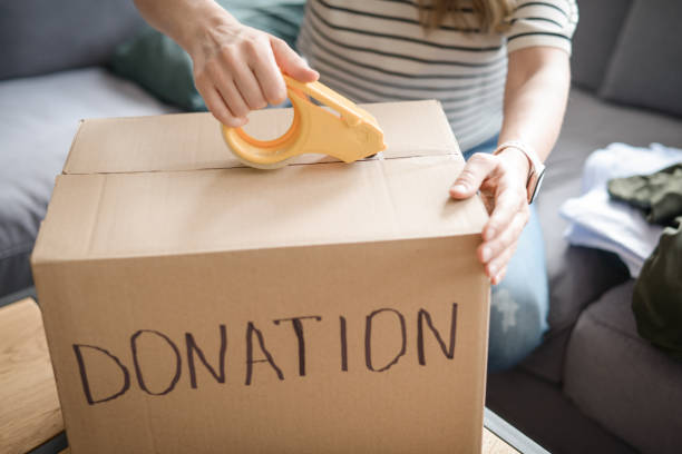 istock woman puts donations in a box 1318334239