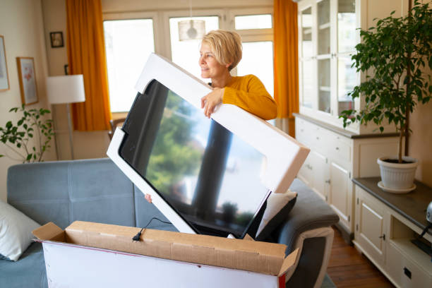 istock New television is so light a woman can unpack it 1318334583