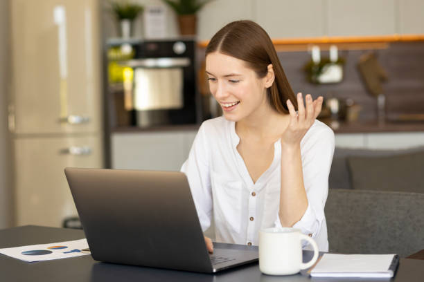 istock Video call communication. Young successful woman talk to colleagues work from home office 1318335634