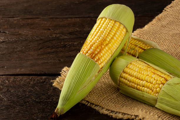 istock Green corn on the wooden table. 1318336898