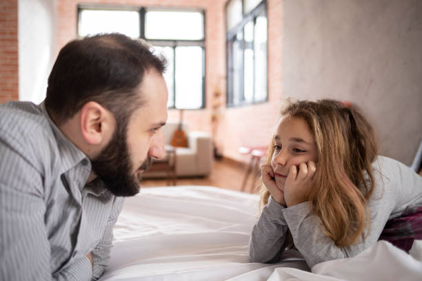 istock Daughter and father looking thoughtfully at each other 1318336927