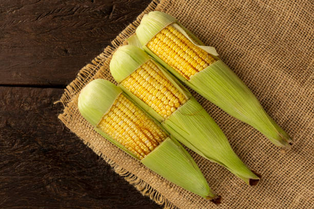 istock Green corn on the wooden table. 1318336948