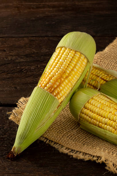 istock Green corn on the wooden table. 1318336977
