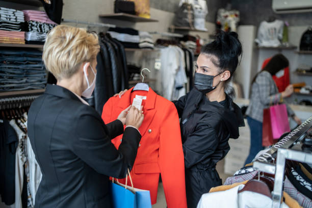 istock Trendy shop worker is assisting a customer with her choices 1318338364