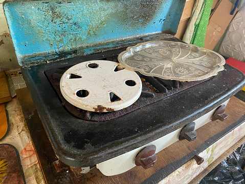 Old dirty little two-burner gas stove for cooking in a beggar's dwelling.