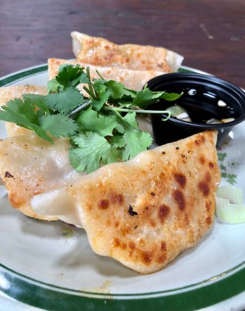 istock Delicious fried dumplings with coriander and soy sauce 1318339329