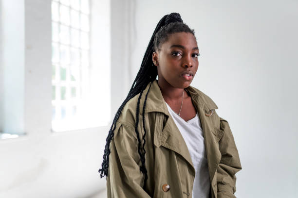 istock Black Young Woman Posing in Studio and Looking at Camera 1318340403