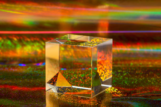 istock Glass crystal cube on abstract holographic background close up. 1318347744