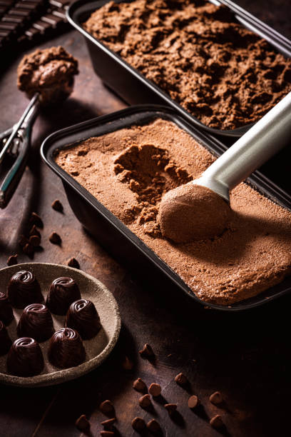 istock Chocolate ice cream scoop ball serving and chocolates macro close-up 1318351533