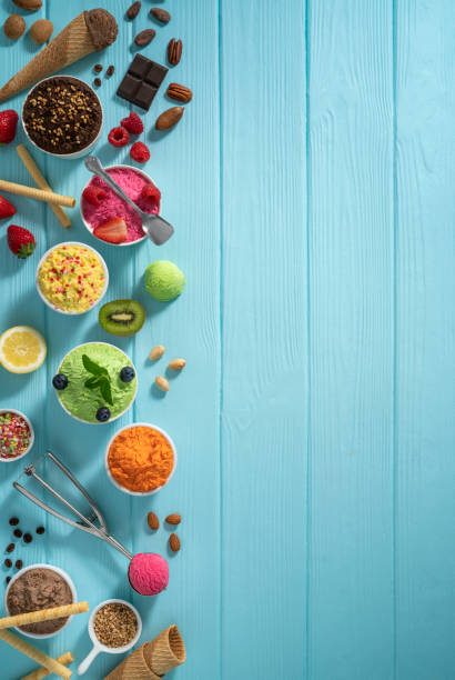 istock Assorted ice cream cups and waffle cones colorful different flavor on blue wood 1318351627