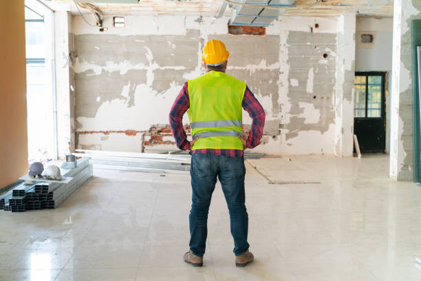 istock maintenance worker standing on the white marble floor and looking the walls before starting work 1318354202