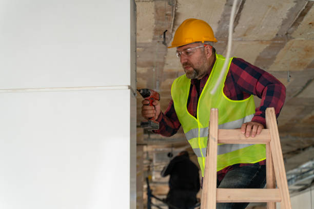istock maintenance worker repairing wall with drill 1318354784