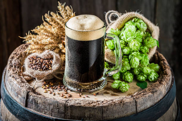 istock Dark beer with foam on old barrel. Brewing industry. 1318355798