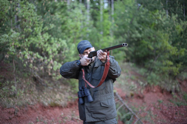 istock Man holding gun stock photo 1318356295