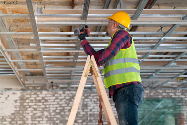 istock worker drilling metal planks on ceiling in construction 1318356300