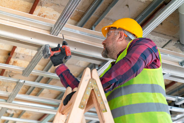 istock Mature worker combining the pieces with drill in construction site 1318356339