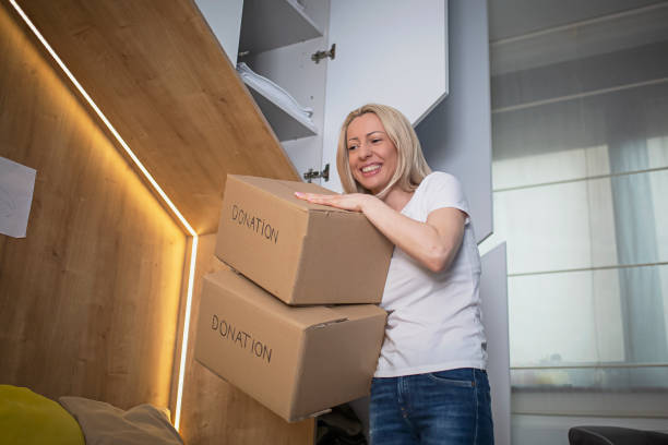 istock Woman sorting clothes from her sons closet for donation 1318357061