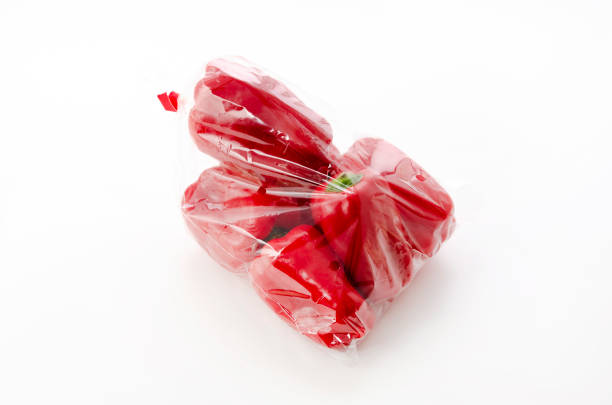 Three whole red bell pepper (capsicum) known as sweet bell pepper, paprika isolated on white background with clipping path.