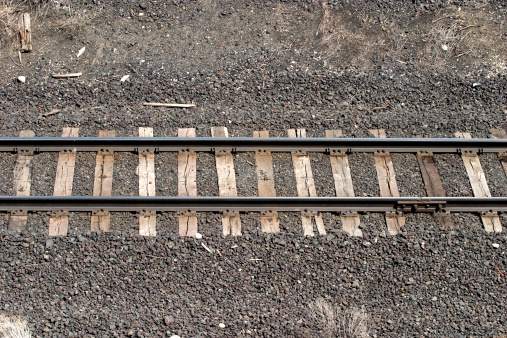 Short length of railroad track going from right to left.