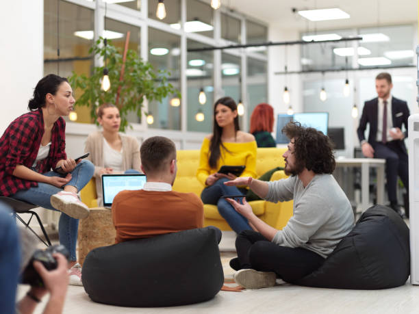 team meeting and brainstorming in modern office business people group in modern office have a team meeting and brainstorming while working on tablet or laptop presenting ideas and take notes working stock pictures, royalty-free photos & images