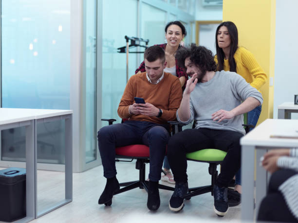 istock Multiethnic startup group at office chair race 1318362061