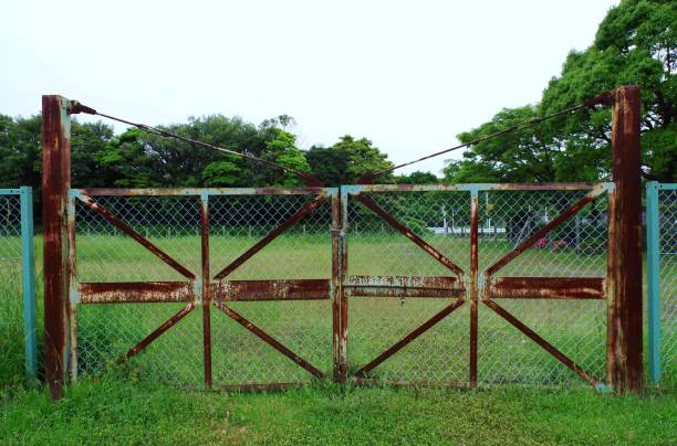 istock Vacant land closed by the rusted gate. 1318363554