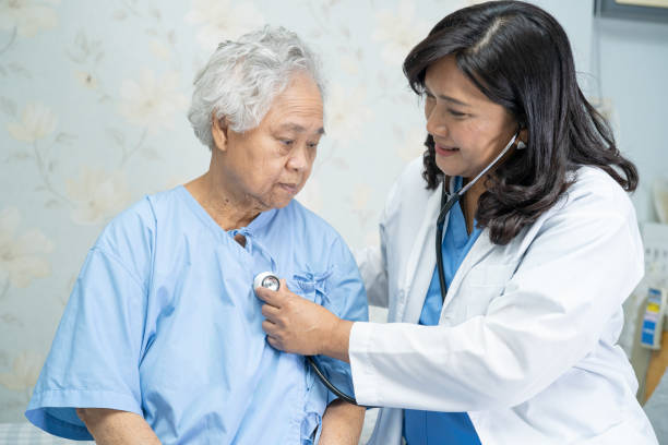 istock Doctor using stethoscope to checking the patient sit down on a bed in the hospital ward, healthy strong medical concept 1318363655
