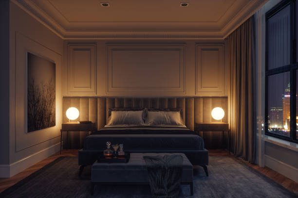 роскошный современный интерьер спальни ночью - cozy bedside стоковые фото и изображения