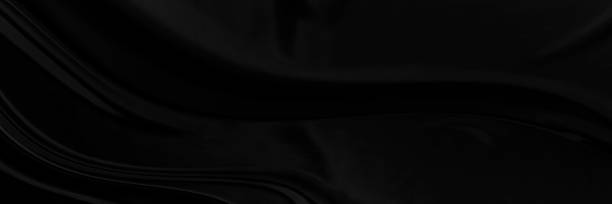 istock Black gray satin dark fabric texture luxurious shiny that is abstract silk cloth panorama background with patterns soft waves blur beautiful. 1318368440