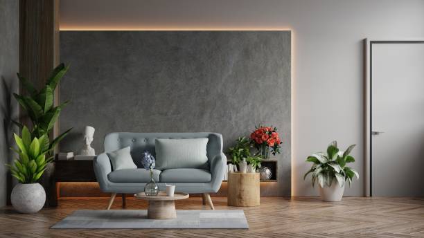 istock Living room loft in industrial style with blue sofa on empty concrete wall background. 1318368545