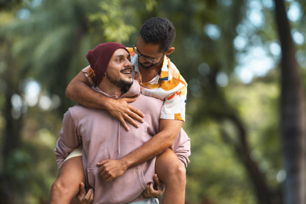 istock Gay man carrying boyfriend on his back 1318368613