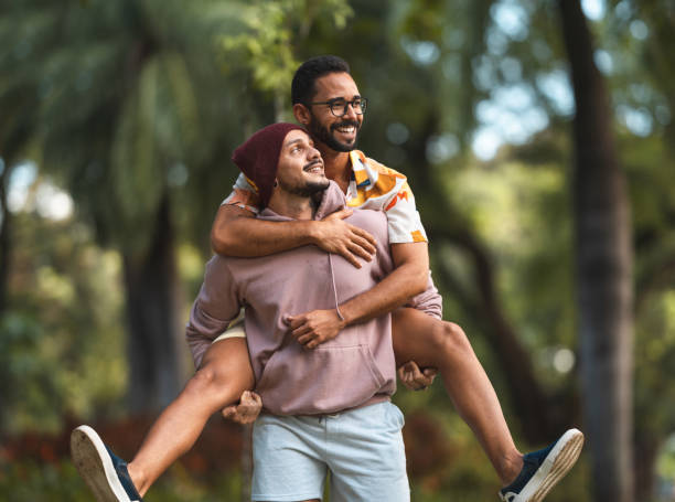 istock Gay man carrying boyfriend on his back 1318368619