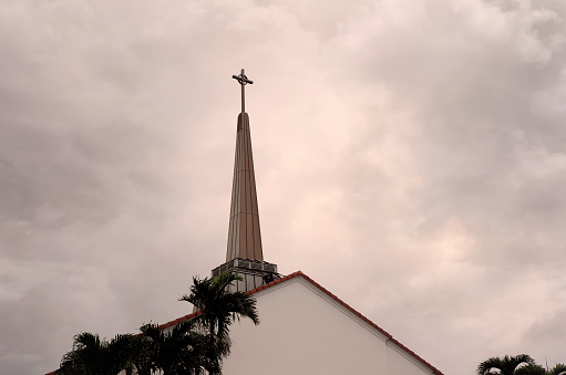 Close up shot from a church and flying birds over stormy sky in Deerfield Beach, Florida.