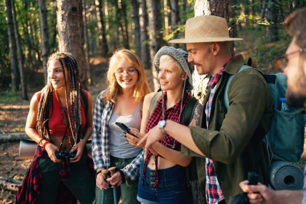 istock Cheerful friends examining map on the smart phone 1318372583