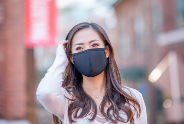 istock Asian woman wearing mask 1318372900